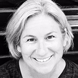 Headshot of LouAnne Boyd, a white woman with grey hair , wearing a blue shirt