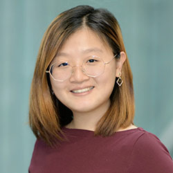 Yuhang Zhao, an Asian woman with short brown hair, wearing octagon-shape eyeglasses and a crimson shirt
