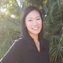 Portrait of Kristen Shinohara, a Japanese American woman wearing a black blouse.