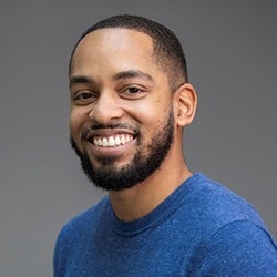 Martez Mott, a Black man with a beard and short black hair, wearing a blue shirt
