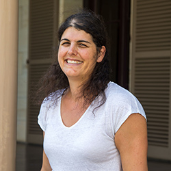 Laurianne Sitbon, a white woman, middle-aged, with dark wavy hair, smiling in the sun