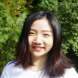 Junhan 'Judy' Kong is an Asian woman with shoulder-length black hair wearing a white T-shirt